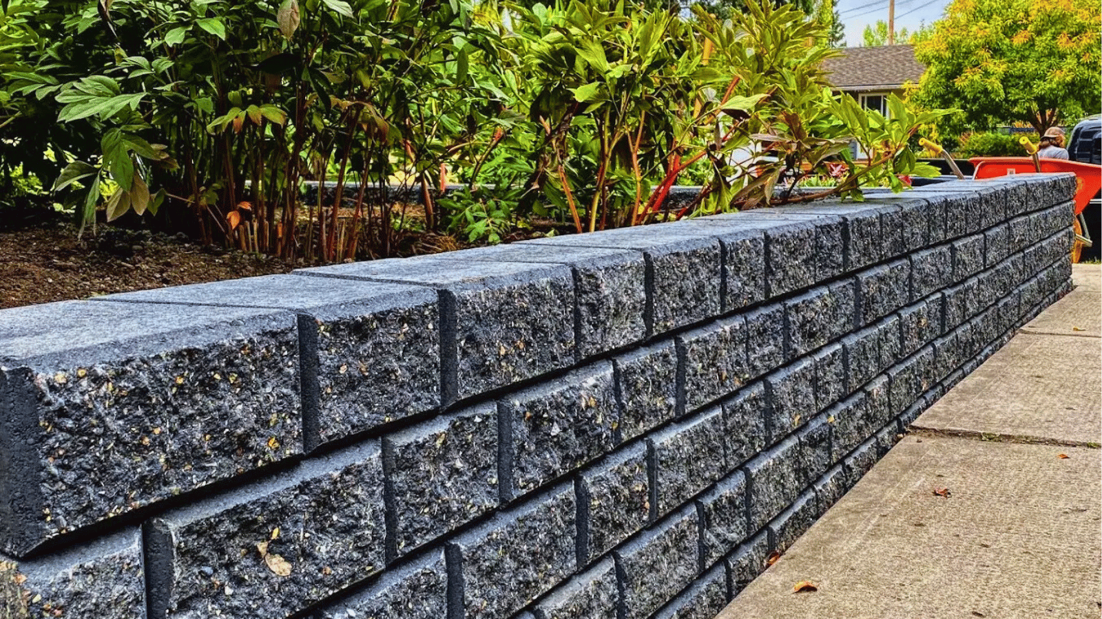 Retaining wall installation in progress by All The Moore Landscaping