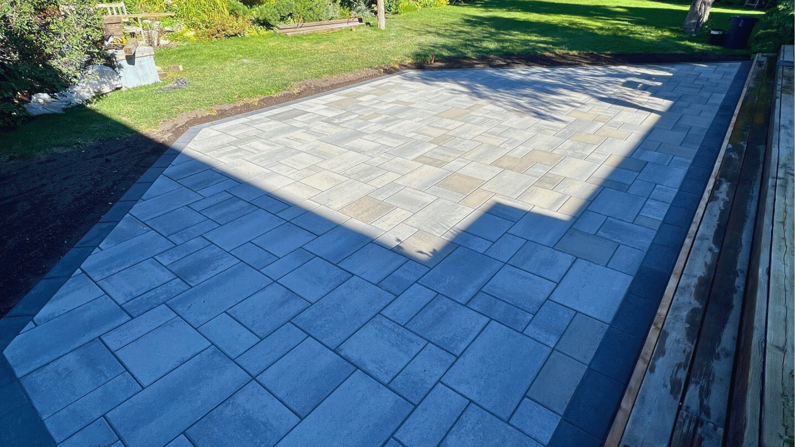 All The Moore Landscaping team building stone patio