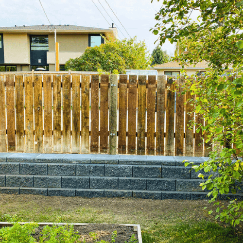 Completed stone retaining wall by All The Moore Landscaping